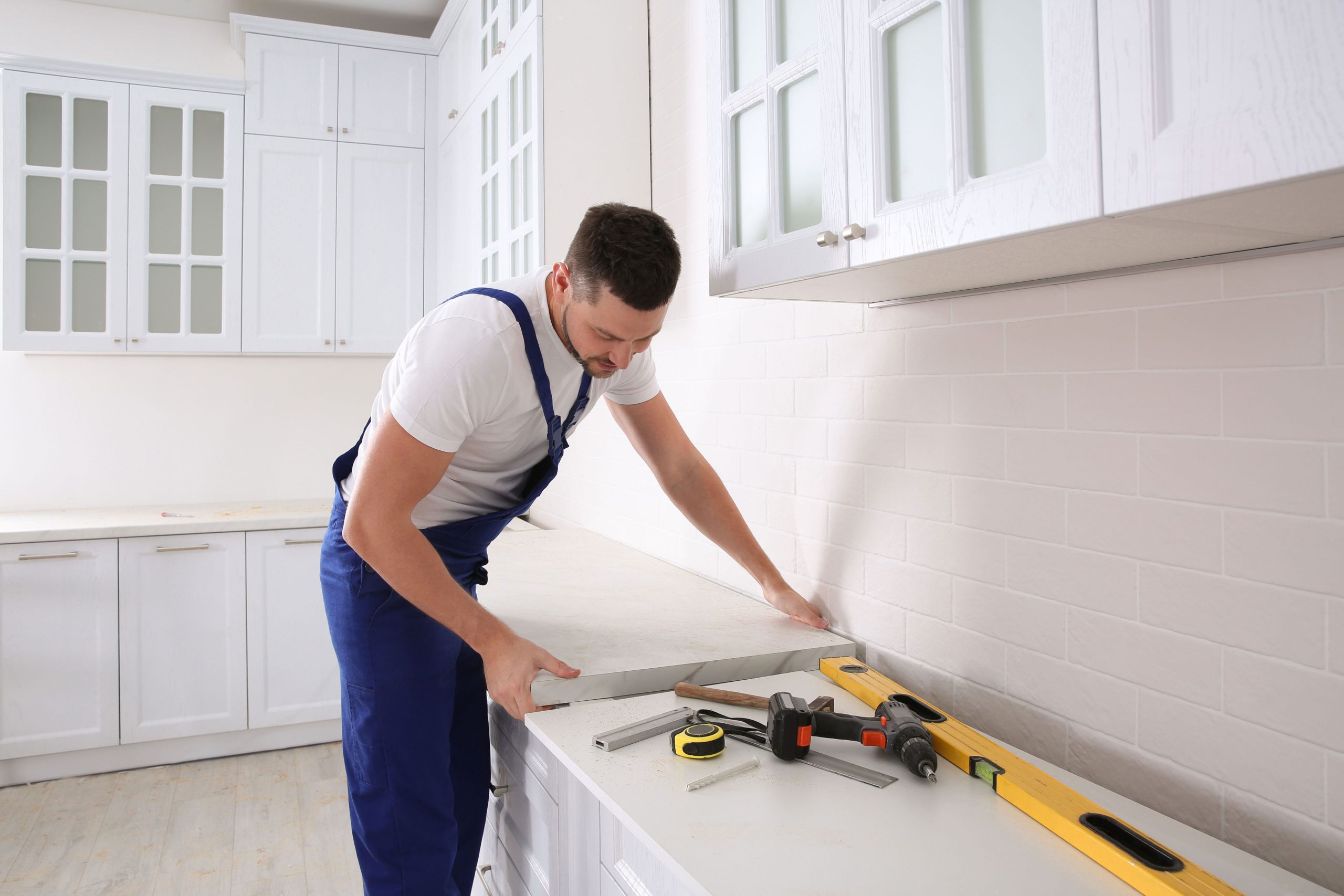 A kitchen remodeling expert installs countertops in a Denton, TX home.